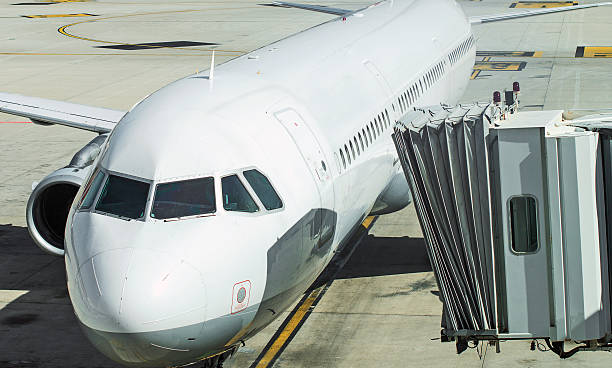 istock Jet bridge docked to the plane. 469661150