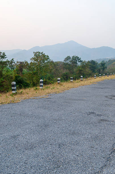 istock roadside pillar in the surface of natural road 469661393