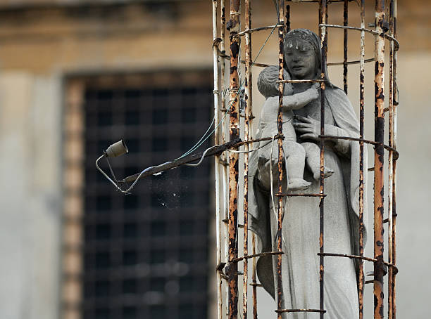 Madonna and baby Jesus in a cage.