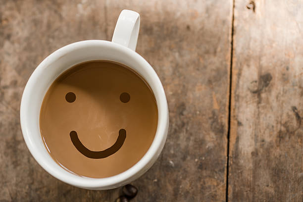 istock Smiling cup of coffee on wooden background 469668519
