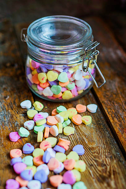 istock Heart candies on rustic wooden background 469669311