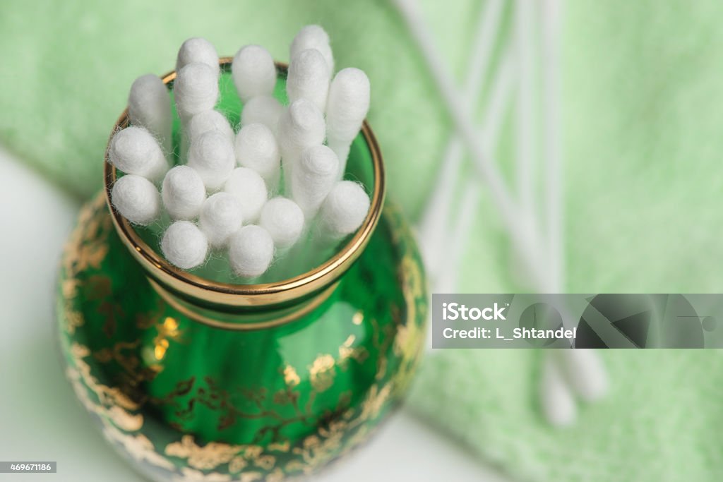 cotton swabs in a green glass vase Cotton ear stick or coli in a green glass vase 2015 Stock Photo