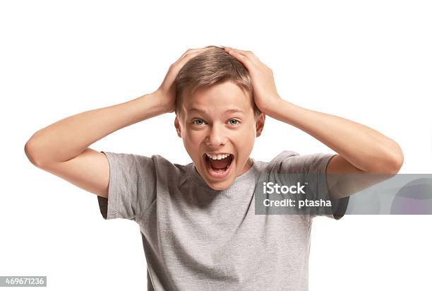 Amazed Teenager Holding His Head Stock Photo - Download Image Now - Surprise, Head In Hands, Boys