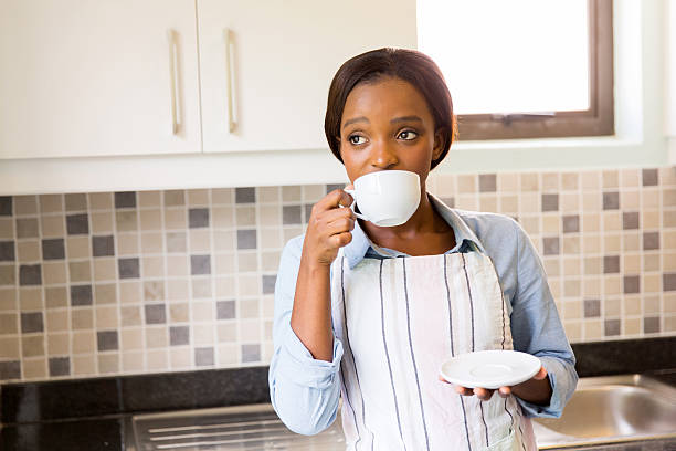 istock thoughtful african woman drinking coffee 469671396