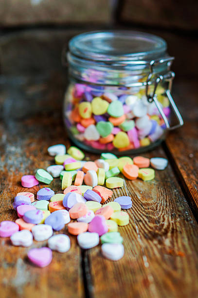 istock Heart candies on rustic wooden background 469671425
