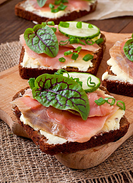 istock Small snacks sandwiches with salty salmon 469671648