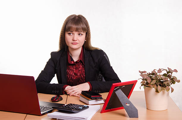 istock Thoughtful girl sitting at office desk 469672646