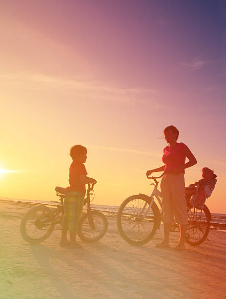 istock mother with kids biking at sunset 469672934