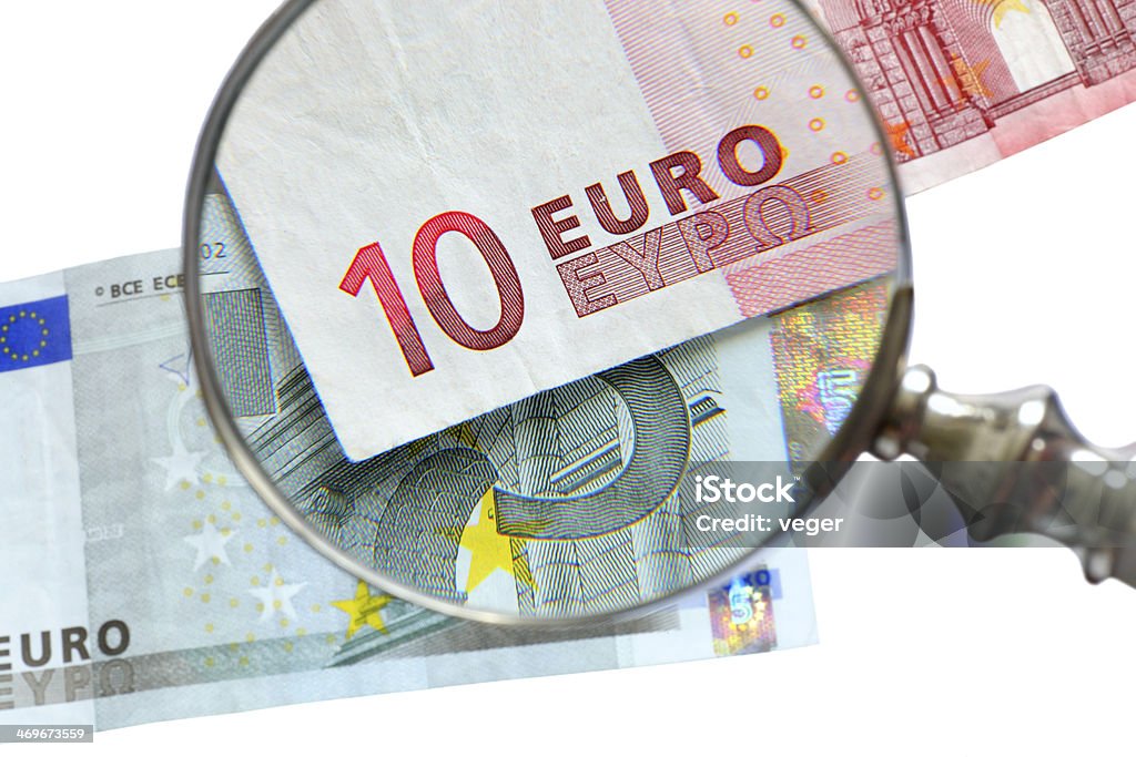 examination of euro banknote examination of euro banknote with magnifying glass European Union Euro Note Stock Photo