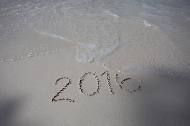 istock Numbers 2016 on beach - concept holiday background 469675766