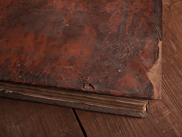 istock Ancient book on the old wooden table 469676242