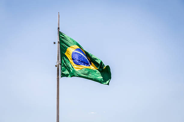 istock Brazilian waving flag on blue sky 469676896