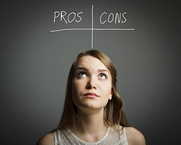 istock A woman looking up at a pros and cons table 469682289