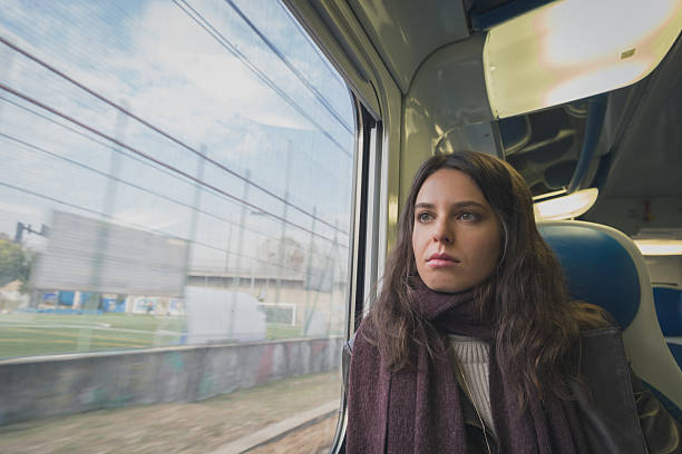 istock Beautiful young brunette travelling by train 469689128