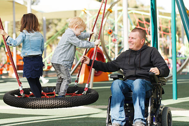 Dad play with son and daughter Disabled Father play with his little son and daughter wheelchair photos stock pictures, royalty-free photos & images