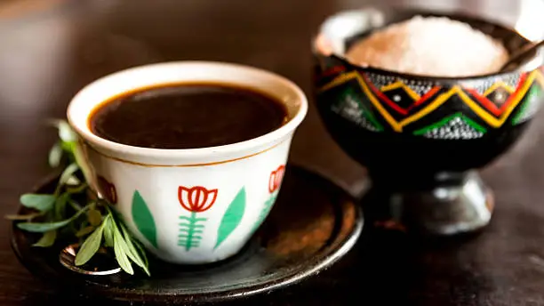 Traditional cup of Ethopian coffee served     with Rue leaf