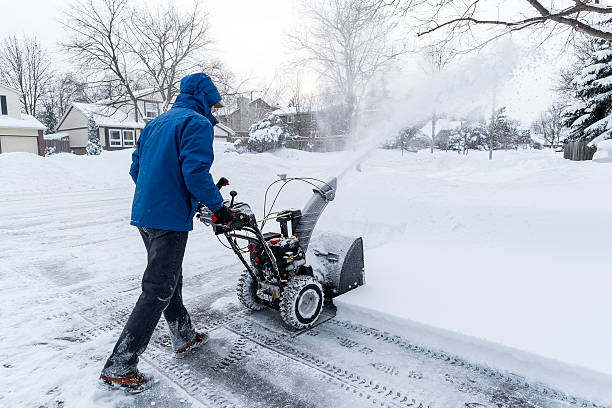 Snow Removal Man clearing snow with a snow blower. winterdienst stock pictures, royalty-free photos & images