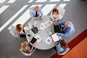 A sales team checking some graphs on a round table