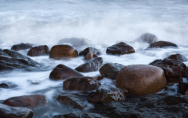 istock round stone in the sea wave 469696864
