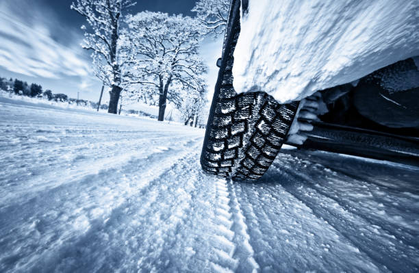 Car tires on winter road Low angle view to car tires. condition stock pictures, royalty-free photos & images