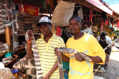 Quy Nhon, Vietnam - 03 March 2024 : Fish seller showing fish to customers at Quy Nhon seafood market in Vietnam