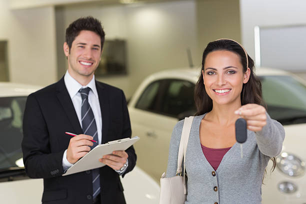 istock Female driver showing key after bying a new car 469697694