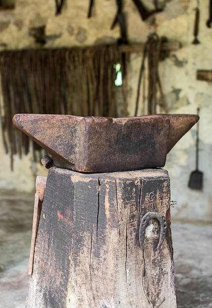 istock Old anvil on the wooden stump. 469703196