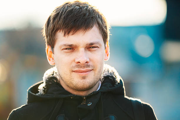 istock Young handsome man outdoors close up portrait. 469703334
