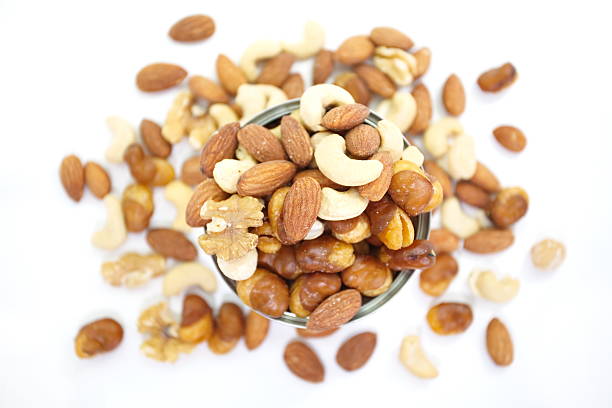 mix of nuts in a cocotte on a white background.