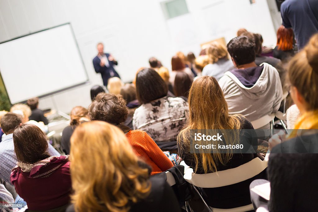 Audience in the lecture hall. Speaker Giving a Talk at Business Meeting. Audience in the conference hall. Business and Entrepreneurship. Copy space on white board. Seminar Stock Photo