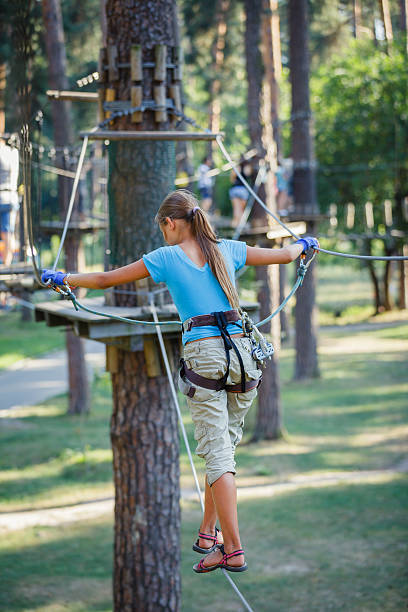 istock Girl in a climbing adventure park 469712432
