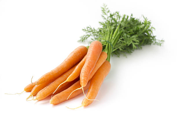 bunch of carrots on white background stock photo