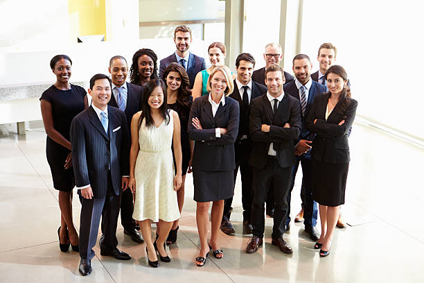 istock Multicultural office staff posing for picture in white lobby 469718263
