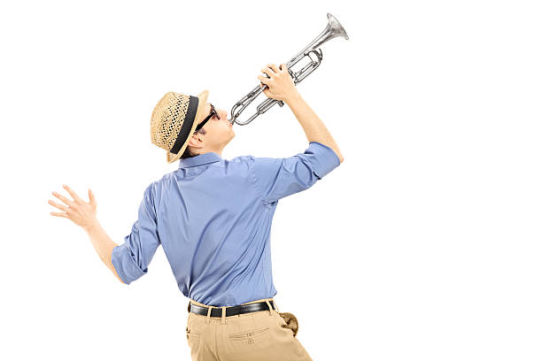 Excited young musician playing trumpet Excited young musician playing trumpet isolated on white background, rear view man trumpet stock pictures, royalty-free photos & images
