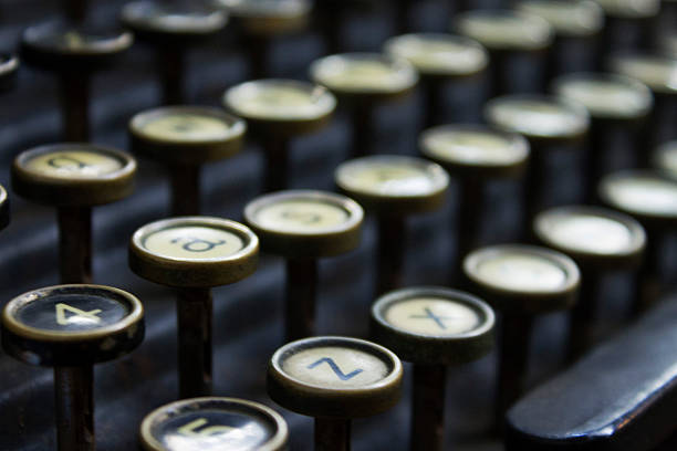 Typewriter Photograph of an antique typewriter keys, focus on the foreground keys A, Z, 4 and 5. typebar stock pictures, royalty-free photos & images