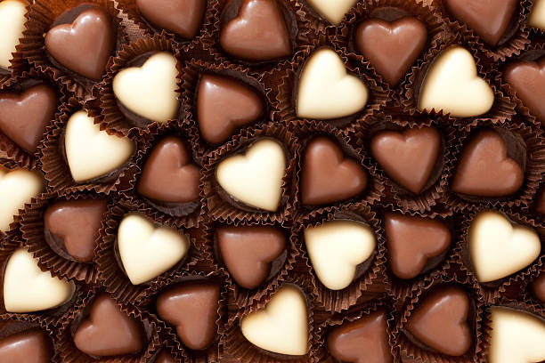Heart shaped chocolates background stock photo