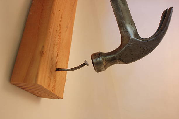 istock Hammer trying to pound in crooked nail 469726004