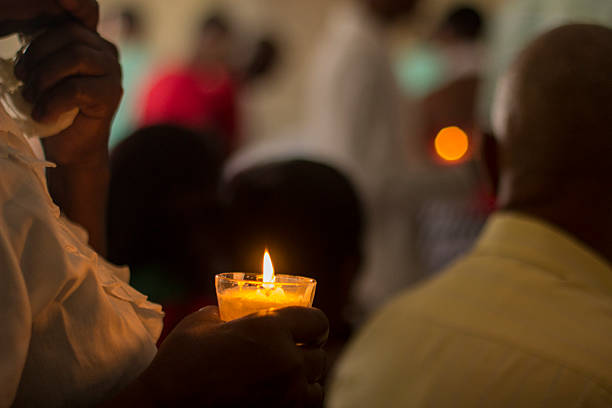 Holding a candle during Mass stock photo