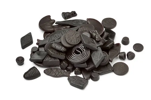 Assorted black and brown liquorice on white background