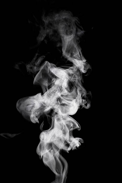 Steam rising in front of a black background stock photo