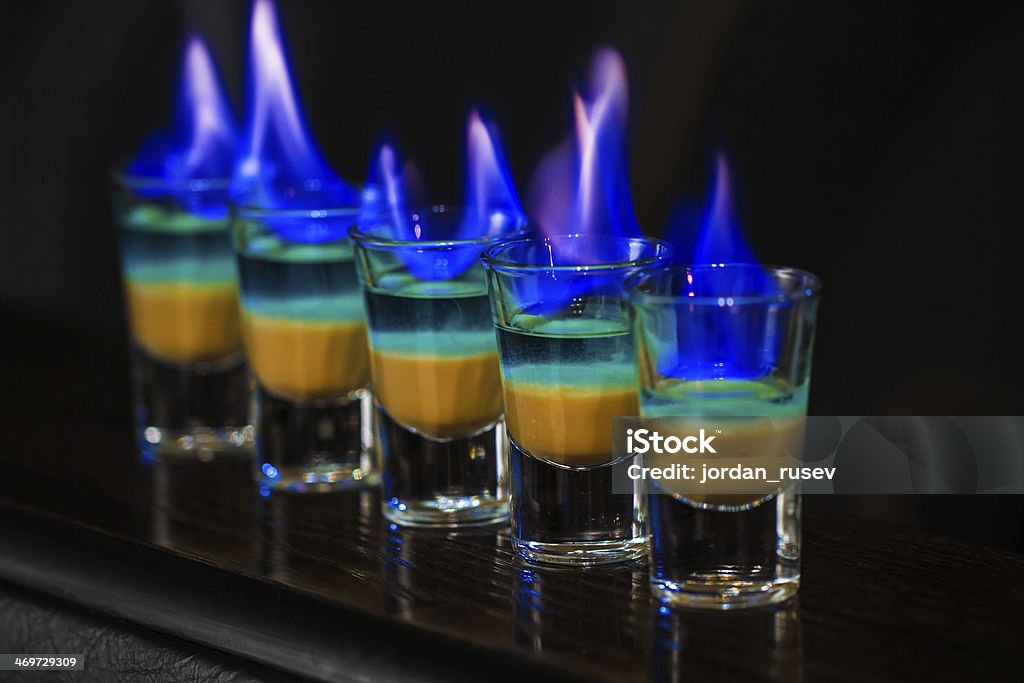 Shots in nightclub Barman make alcoholic shots in nightclub Absence Stock Photo