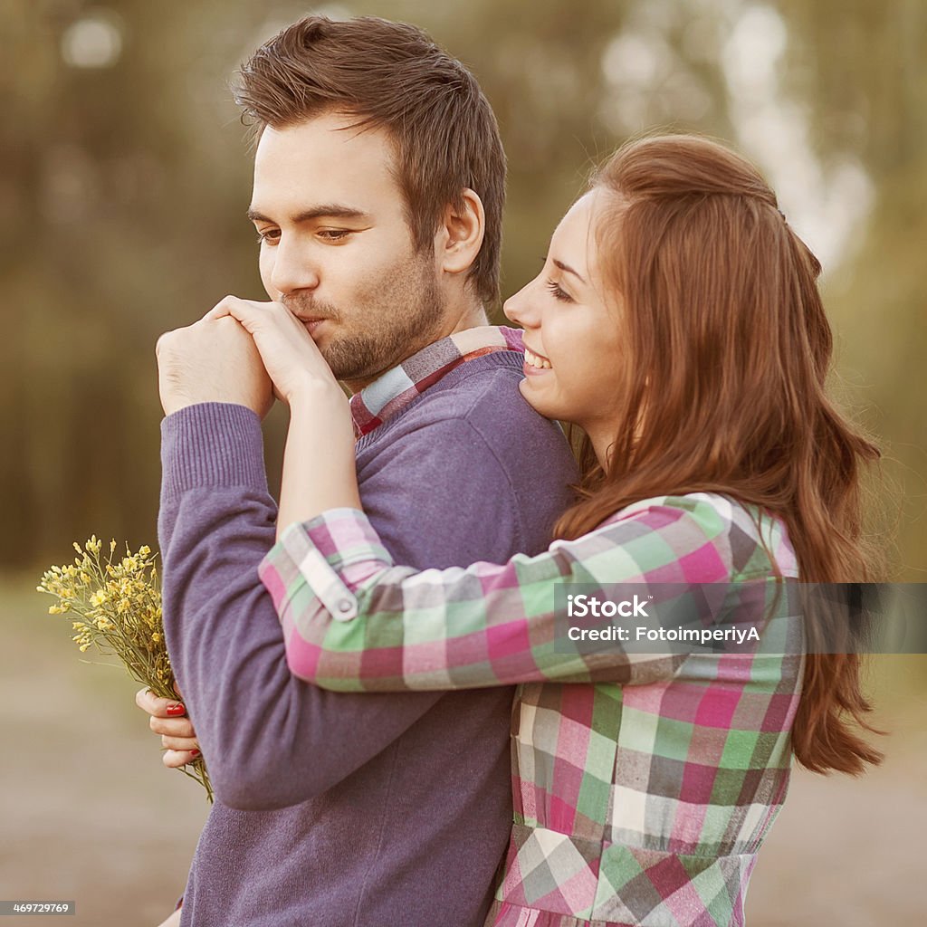 Young couple in love. guy kisses the girl's hand in park Adult Stock Photo