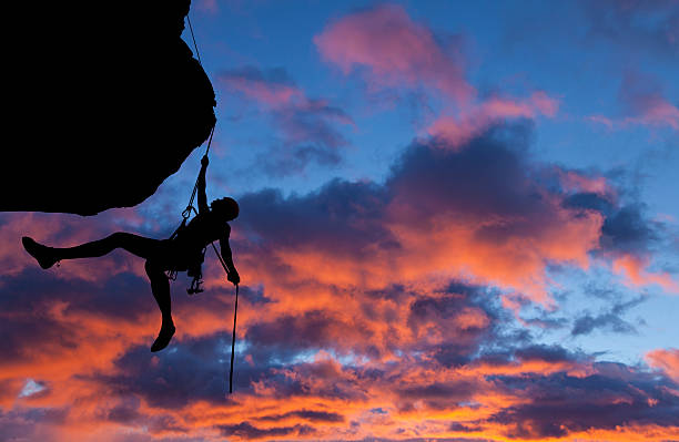 istock Silhouette of a climber doing rappelling at sunset 469729914