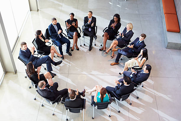 istock Multi-Cultural Office Staff Applauding During Meeting 469733529