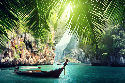 long boat and rocks on railay beach in Krabi, Thailand