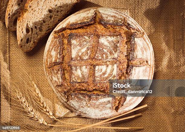 Rustic Bread And Wheat On A Traditional Cloth Stock Photo - Download Image Now - 2015, Baked Pastry Item, Bakery