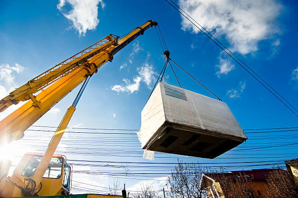 istock Industrial Crane operating and lifting an electric generator 469734211