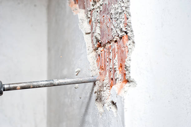 istock Close-up of jackhammer distroying an inside wall in construction 469734213