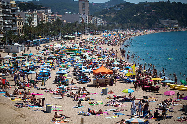 istock People and sun umbrellas on the beach 469734308