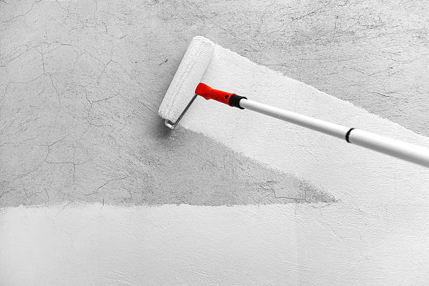 Painting With White Paint by Roller stock photo